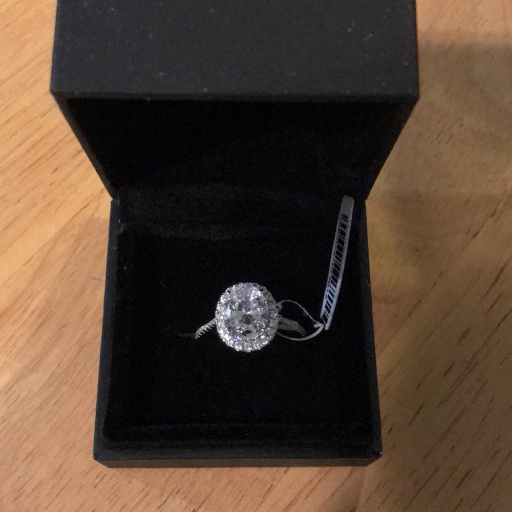 Oval cut white sapphire halo ring